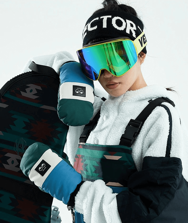 Woman in ski gear wearing ultralight thickened waterproof gloves holding a snowboard, showcasing winter sports fashion.