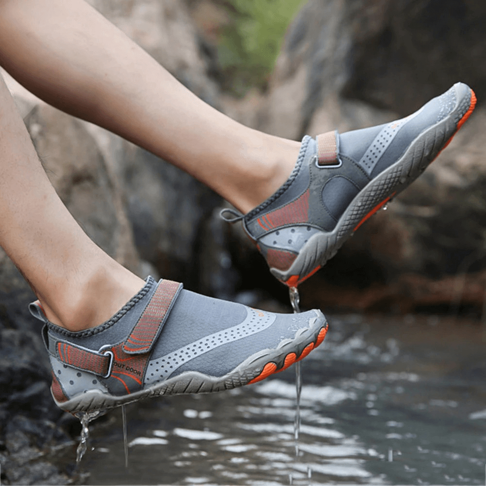 Person wearing gray Unisex Breathable Nonslip Aquatic Sneakers, perfect for water activities, featuring nonslip soles and hook & loop closure.