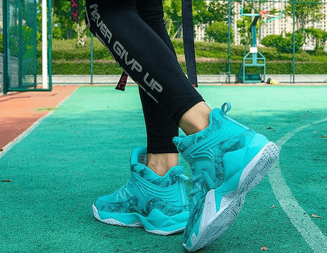 Unisex Lace-Up Antiskid Basketball Shoes on court, featuring vibrant blue design, mesh upper, and cushioning for comfort and style.