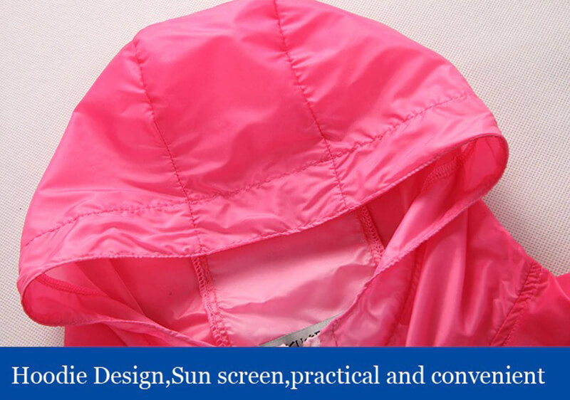 Close-up of pink windbreaker hood, highlighting the practical, sun-screen design ideal for outdoor activities.