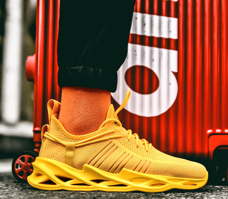 Yellow unisex mesh breathable running shoes with lace-up design and unique outsole, showcased with bold orange socks.