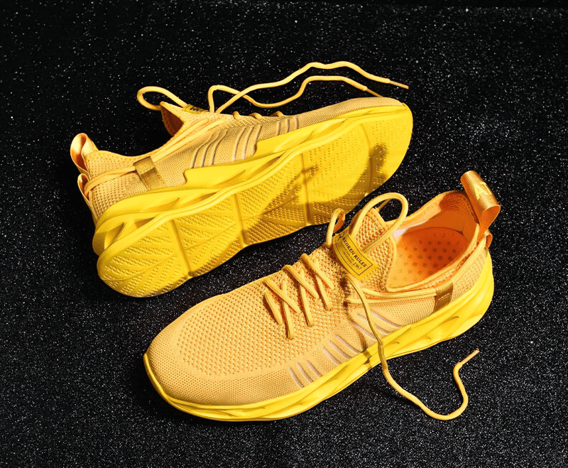 Yellow unisex mesh breathable running shoes with lace-up design on black surface, featuring EVA outsole and PU leather insole.