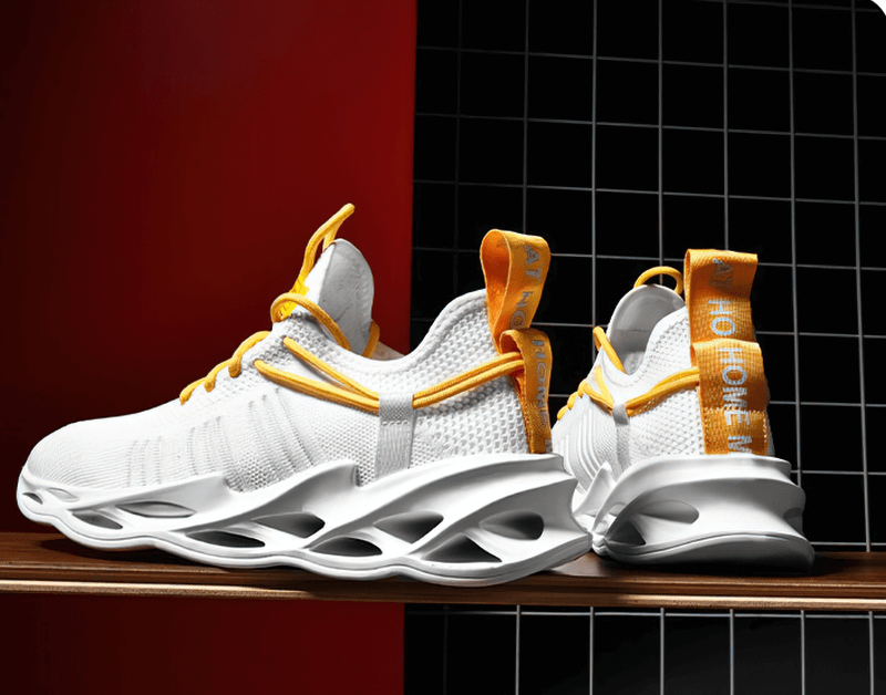 Stylish unisex mesh breathable running shoes with white and orange design on display.