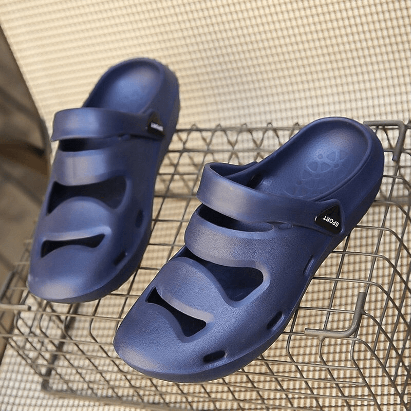 Blue unisex hollow clogs slippers with rubber outsole on a metal rack, perfect for outdoor comfort and style, model SF0640.