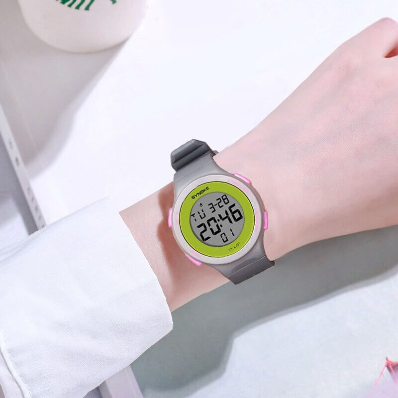 Zoom on wrist wearing a unisex ultra-thin digital watch, featuring a green LED display, waterproofing, and shock resistance features.
