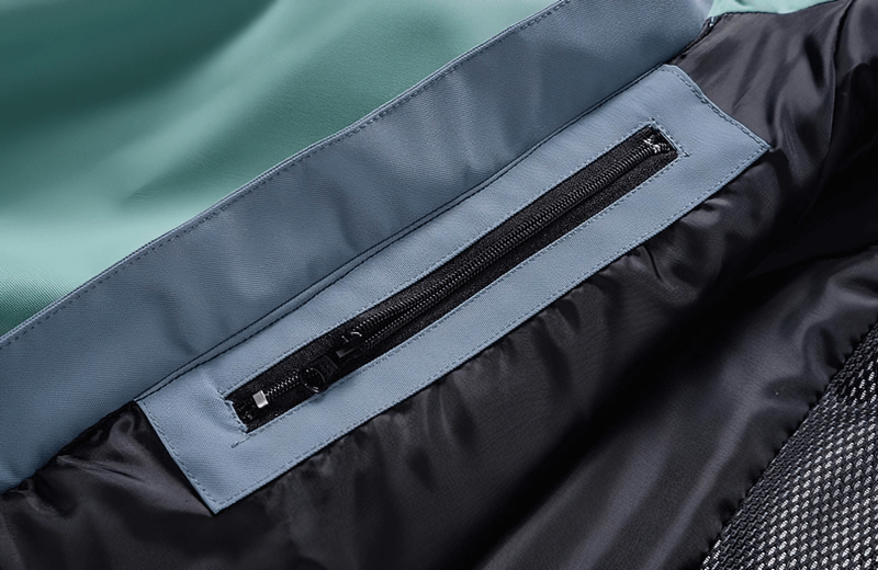 Close-up of waterproof snowboarding jacket zipper detail highlighting durability and design.