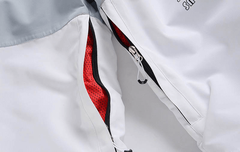 Close-up view of waterproof zipper and breathable mesh in snowboarding pants with strap, demonstrating quality and functionality for skiing.