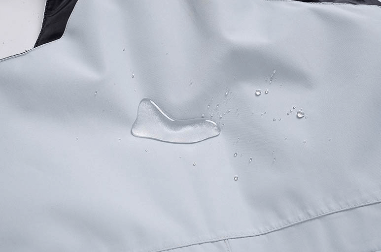 Close-up of waterproof fabric on snowboarding pants, showcasing water-resistant performance for skiing and winter sports.