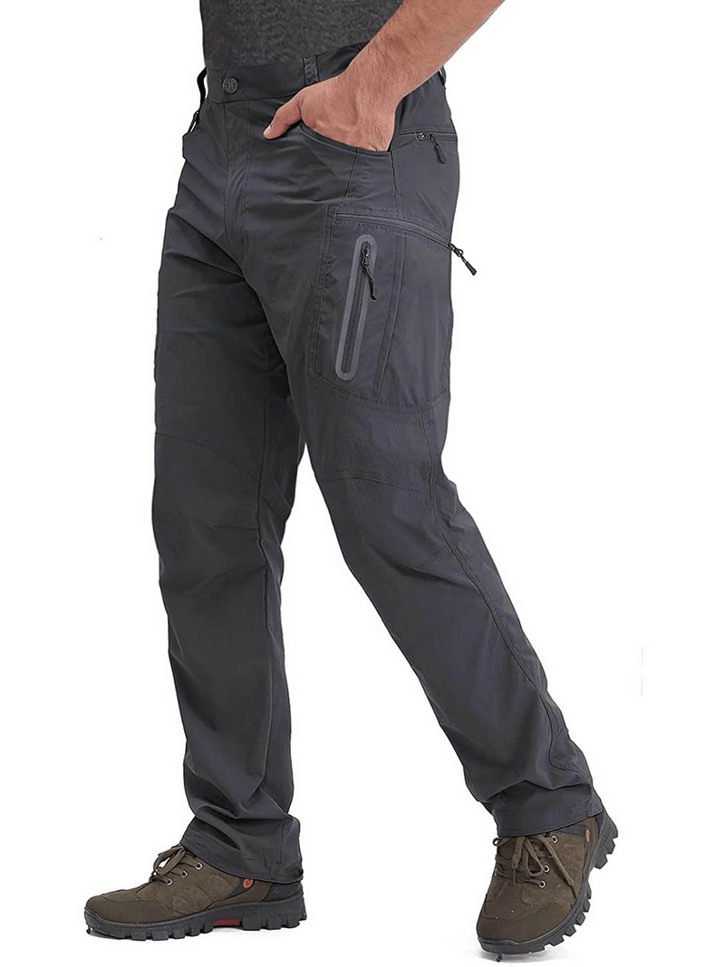 Man wearing water resistant lightweight fishing pants with zipper pockets, perfect for outdoor activities.