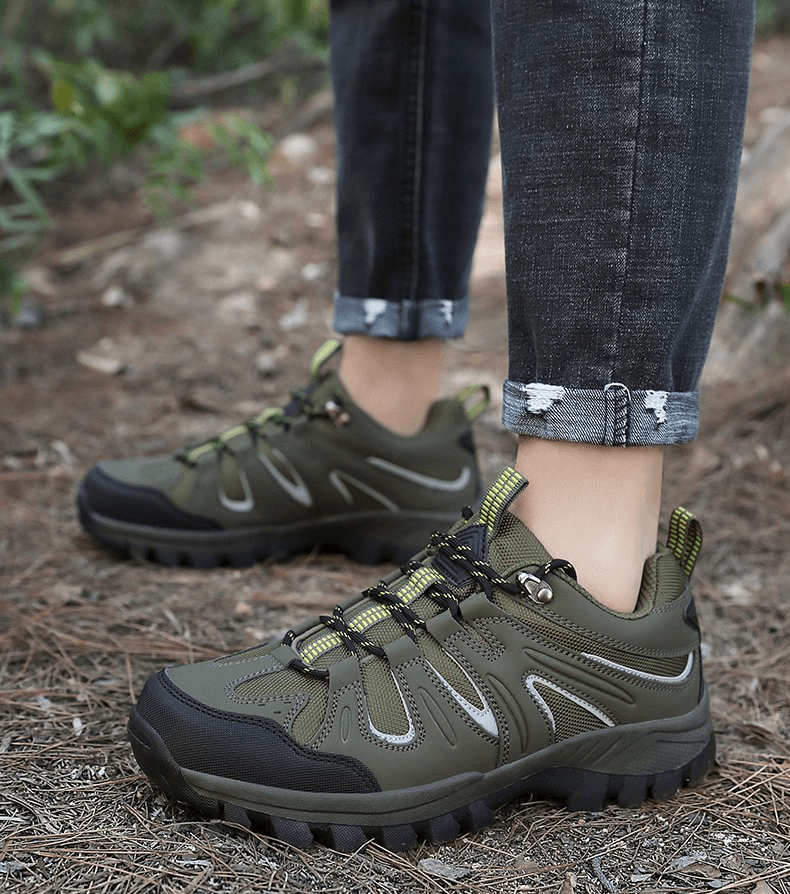 Man wearing waterproof anti-slip trekking shoes, featuring lace-up design and rugged outsole, ideal for outdoor adventures.