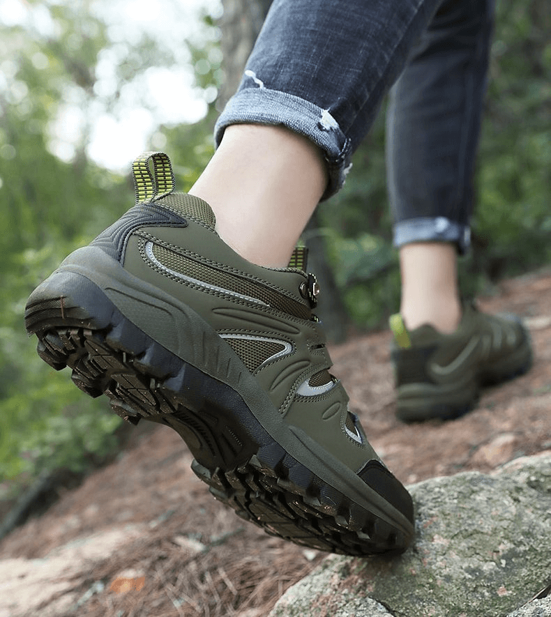 Waterproof anti-slip men's trekking shoes with rubber outsole, perfect for outdoor adventures, shown in a forest setting.