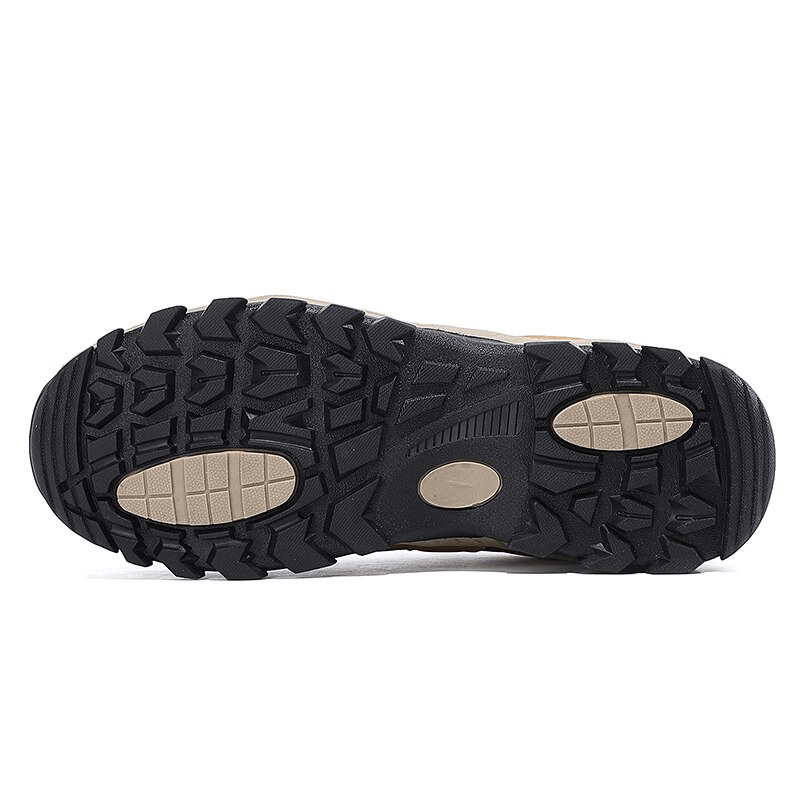 Close-up of the rugged rubber outsole of men's waterproof anti-slip trekking shoes, designed for superior traction on outdoor adventures.