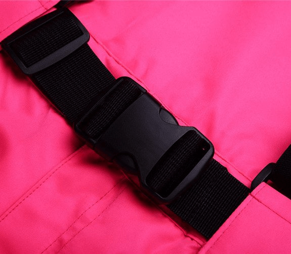 Close-up of pink waterproof breathable ski pants with black suspenders and secure buckle, ideal for warmth and winter comfort.