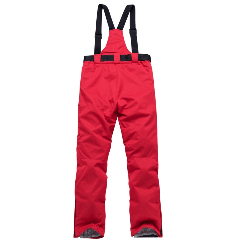 Red waterproof breathable insulated ski pants with suspenders, designed for warmth and comfort in winter sports.