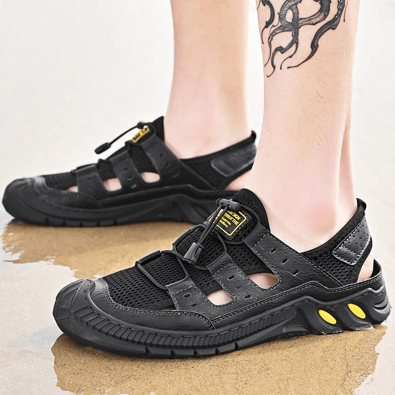 Hollow-Out Breathable Mesh Sandals with wear-resistant rubber sole on wet surface, showcasing lightweight design and durability.