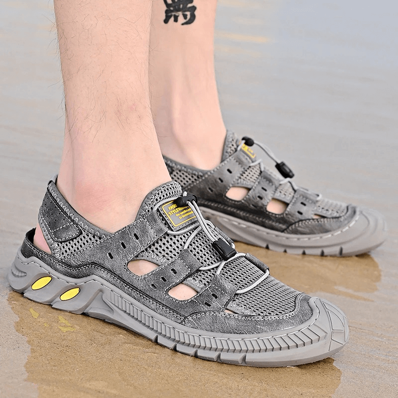 Hollow-Out Breathable Mesh Sandals with wear-resistant rubber sole, perfect for comfort and style on sandy beaches.