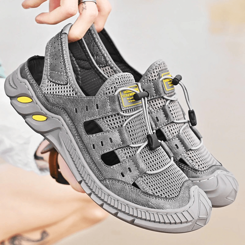 Gray hollow-out breathable mesh sandals with wear-resistant rubber sole, showcasing lightweight design and stylish comfort.