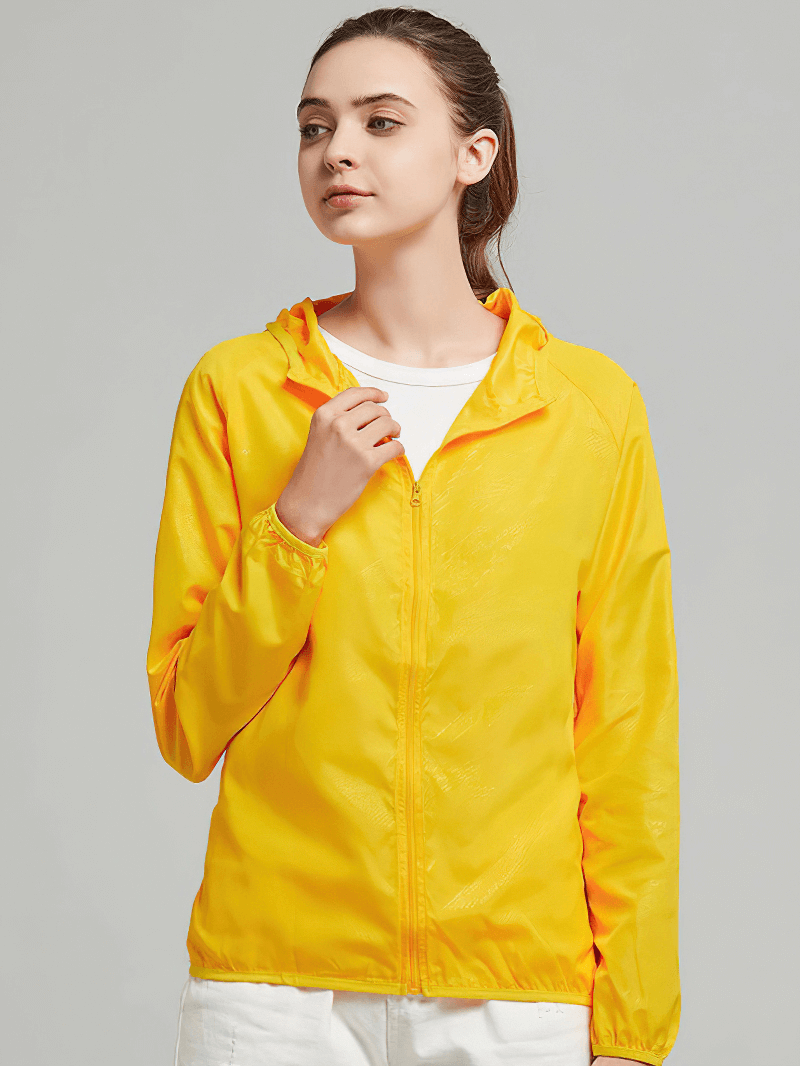 Unisex waterproof hooded jacket in bright yellow, ideal for outdoor activities like hiking and camping. Model wearing jacket SF0377.