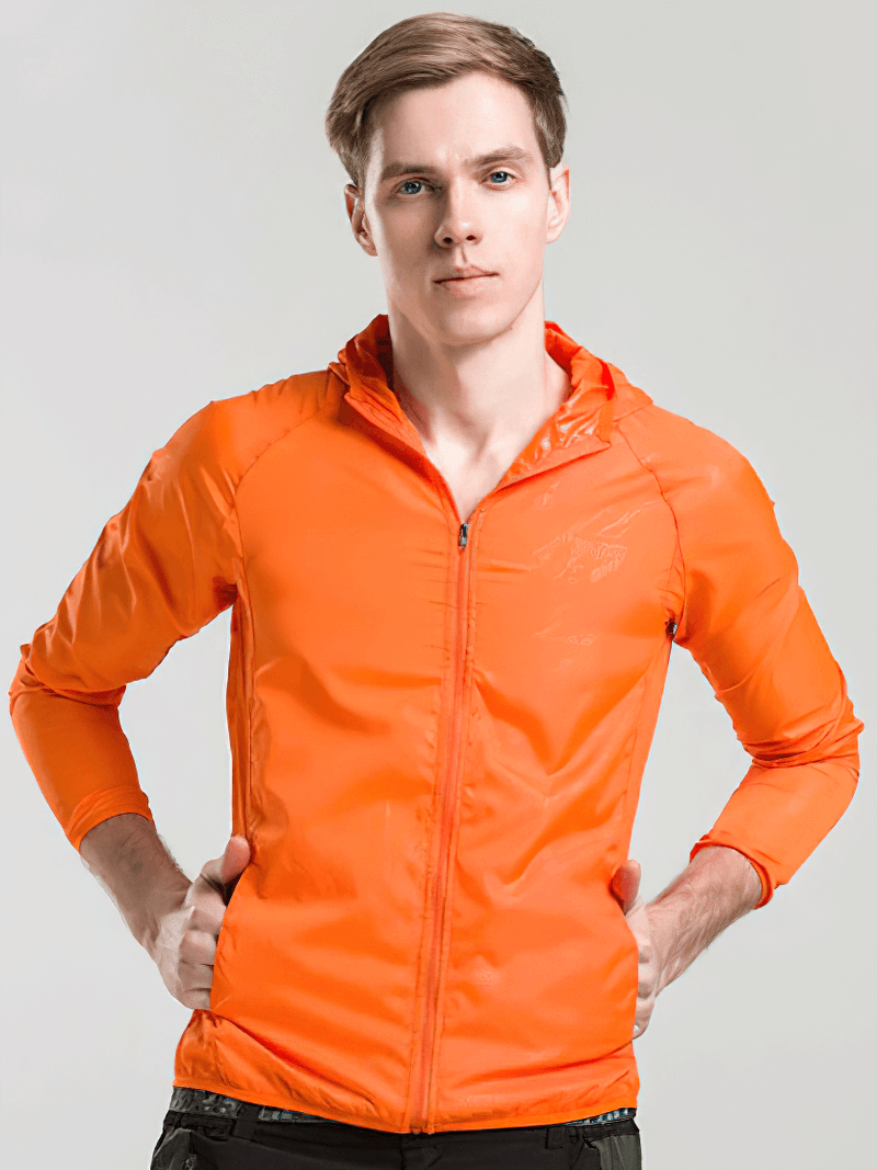 Unisex waterproof jacket with hood in vibrant orange, perfect for outdoor activities like hiking and camping. Model showcasing front view.
