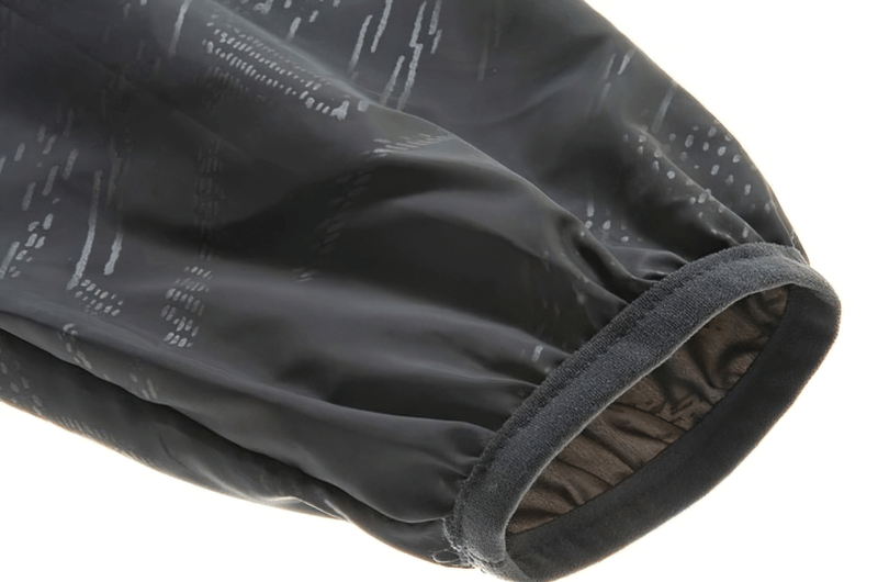 Close-up of waterproof hooded jacket sleeve, showing nylon material and elastic cuff. Ideal for outdoor activities, unisex design.