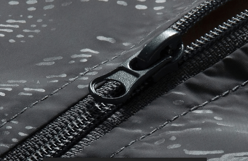 Close-up of waterproof jacket zipper showcasing durable design and quick-dry technology for outdoor protection.