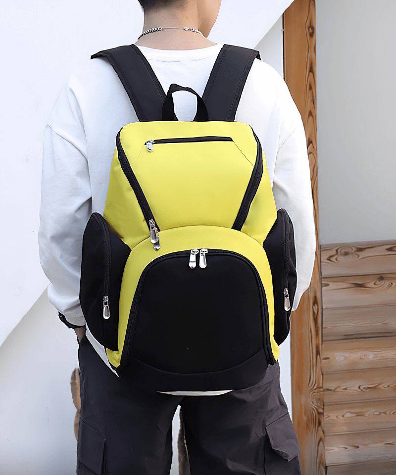 Person wearing a waterproof lightweight football backpack with large capacity, featuring multiple compartments for organization.