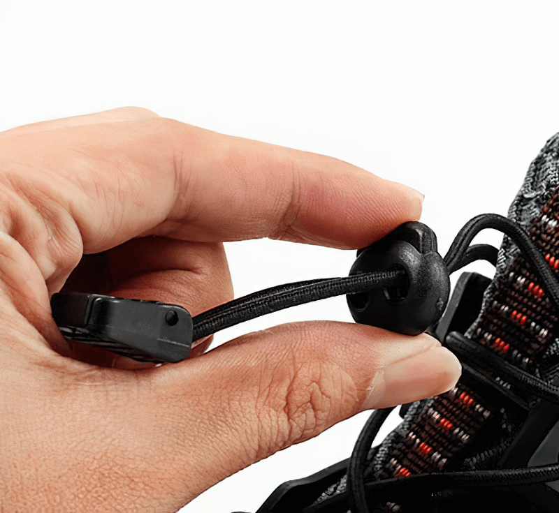 Close-up of tightening laces on waterproof non-slip climbing sneaker for men, showcasing durable and practical design.