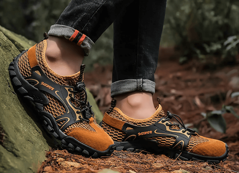 Men's waterproof non-slip climbing sneakers in orange and black with flexible rubber outsole, perfect for outdoor hiking and style.