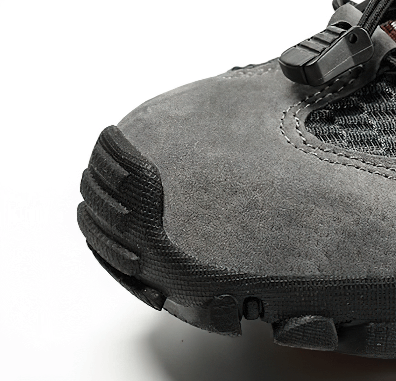 Close-up of gray waterproof non-slip climbing sneaker with sturdy rubber sole for men.