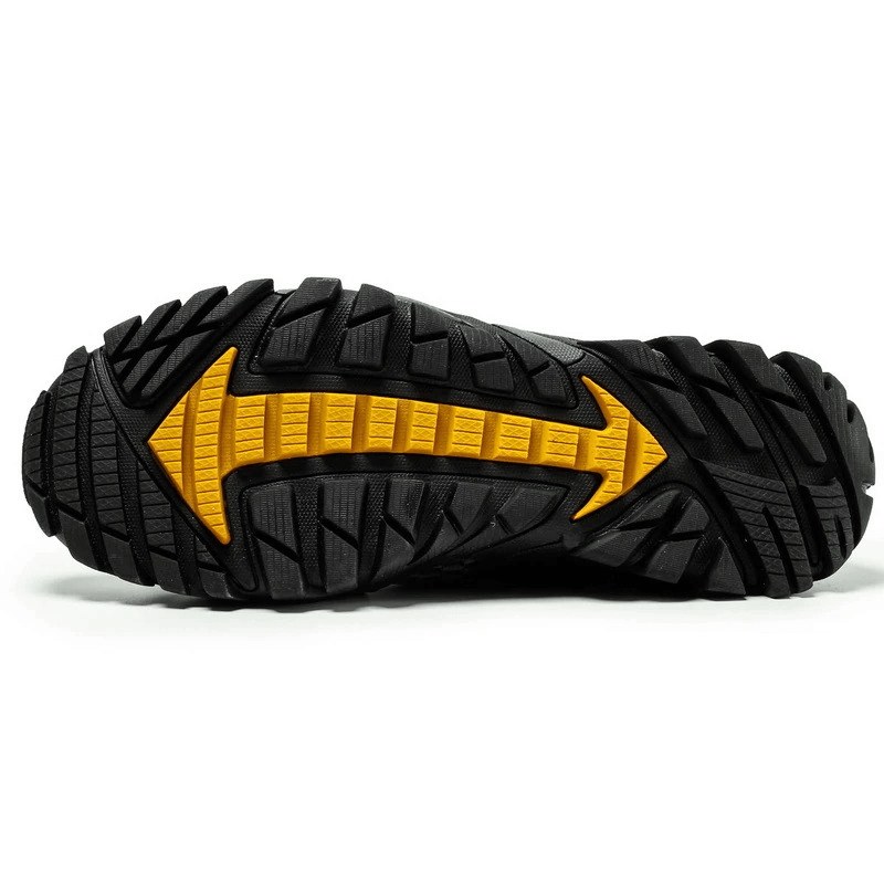 Close-up of black and yellow rubber outsole with superior traction tread, designed for waterproof non-slip climbing sneakers, SF0579.