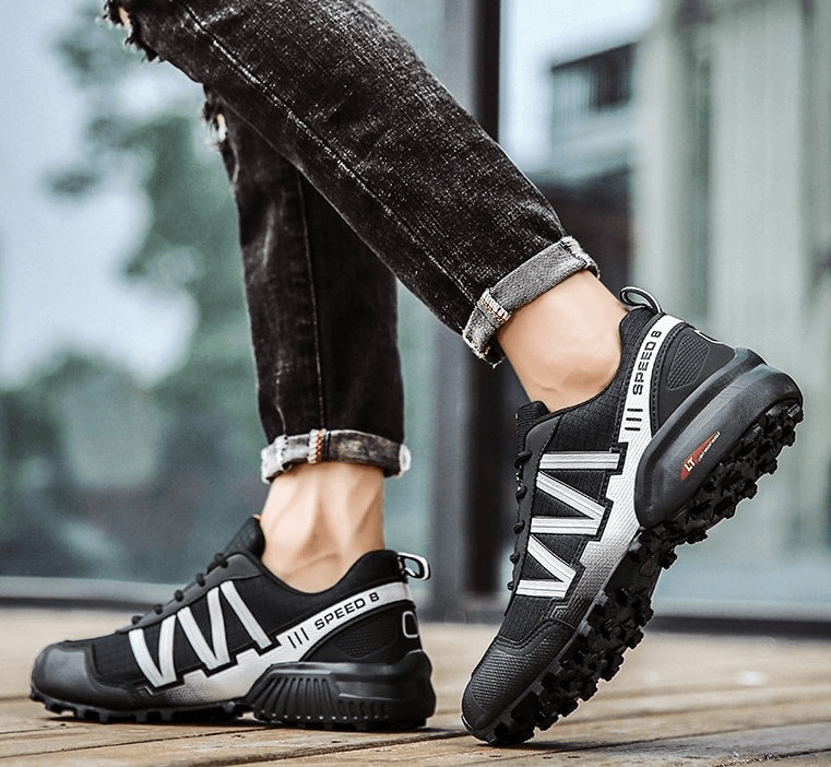 Man wearing waterproof non-slip black geometric design sneakers, perfect for sports and casual outings on rainy days.