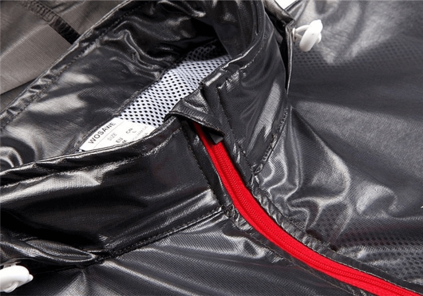 Close-up of a black waterproof reflective bike rain cover with a hood, featuring a vibrant red zipper, ideal for male cyclists.