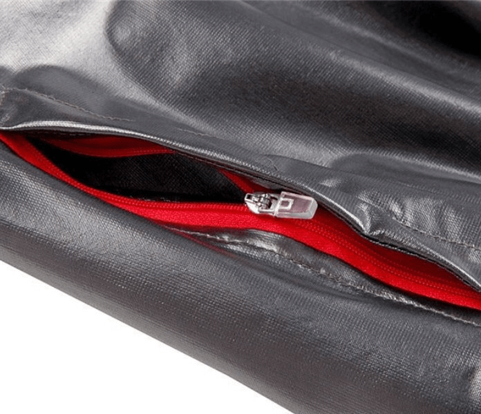 Close-up of waterproof reflective bike rain cover with metal zipper and red lining, offering stylish protection for cyclists.