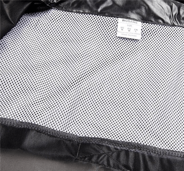 Close-up of the interior mesh lining of a waterproof reflective bike rain cover, showcasing breathable fabric and care label.