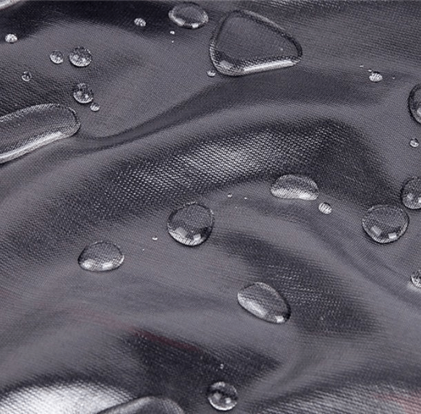 Close-up of waterproof reflective bike rain cover fabric with water droplets, showcasing durability and weather protection.