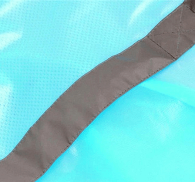 Close-up of waterproof reflective bike rain cover fabric, highlighting durable stitching and breathable polyester material in blue.