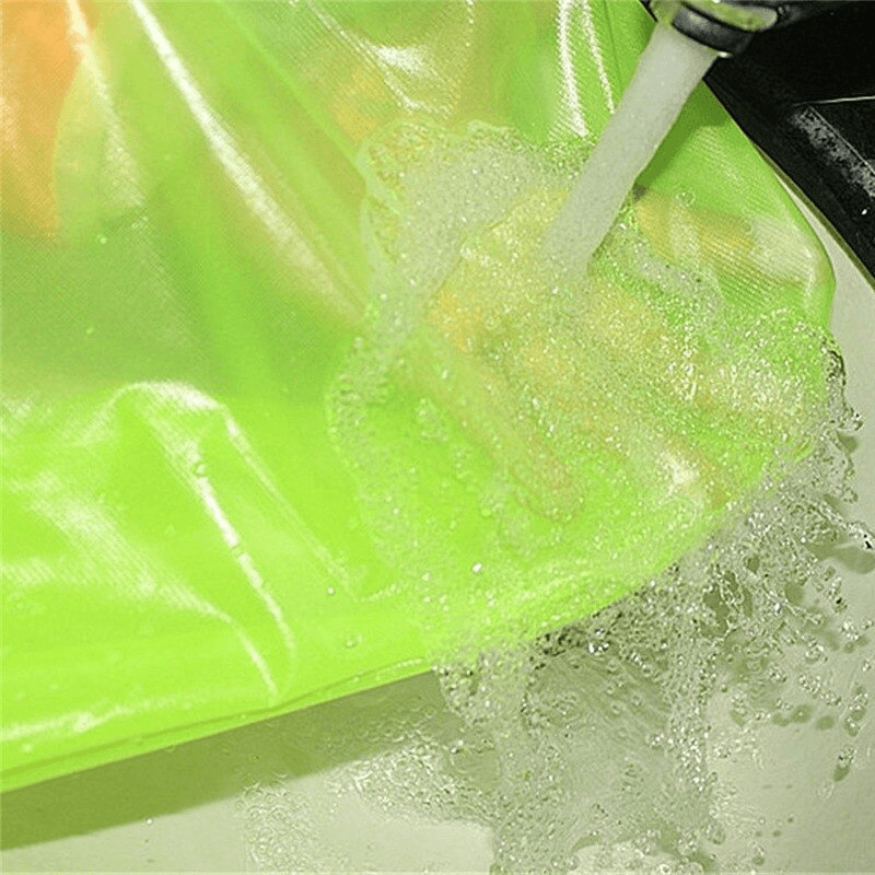 Waterproof reflective bike rain cover with hood demonstrating water resistance with soap bubbles under running water.