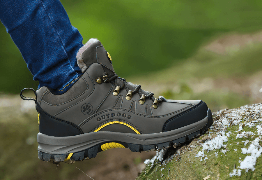 Person wearing waterproof snow trekking boots with anti-collision toe, ideal for outdoor winter adventures - SF0293