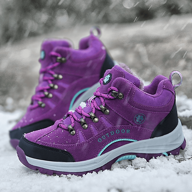 Purple waterproof snow trekking boots with anti-collision toe in snowy outdoors, featuring plush lining and rubber outsoles.
