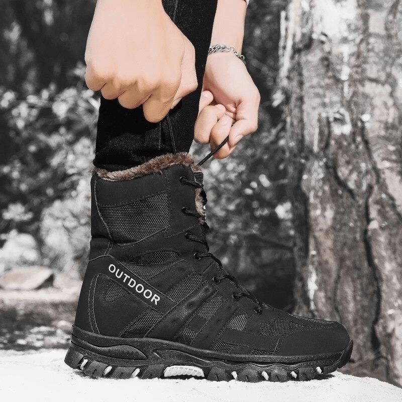 Man lacing up black waterproof motorcycle boots with plush lining and rubber outsole designed for warmth and comfort.