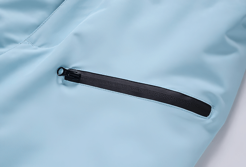 Close-up of black zip pocket on light blue waterproof snowboarding trousers, SF0688 model.