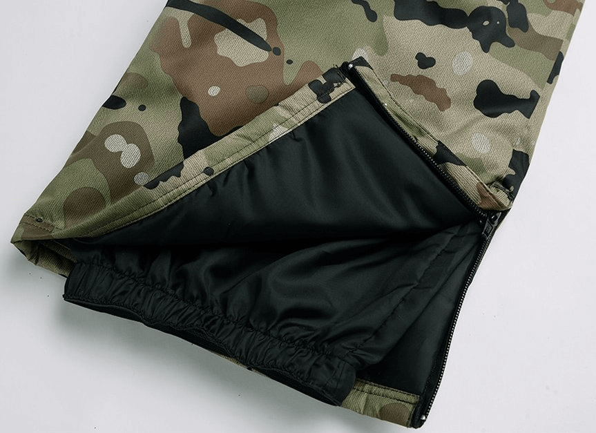 Camouflage waterproof windproof insulated men's pants with zipper and black lining for winter sports like skiing or snowboarding.