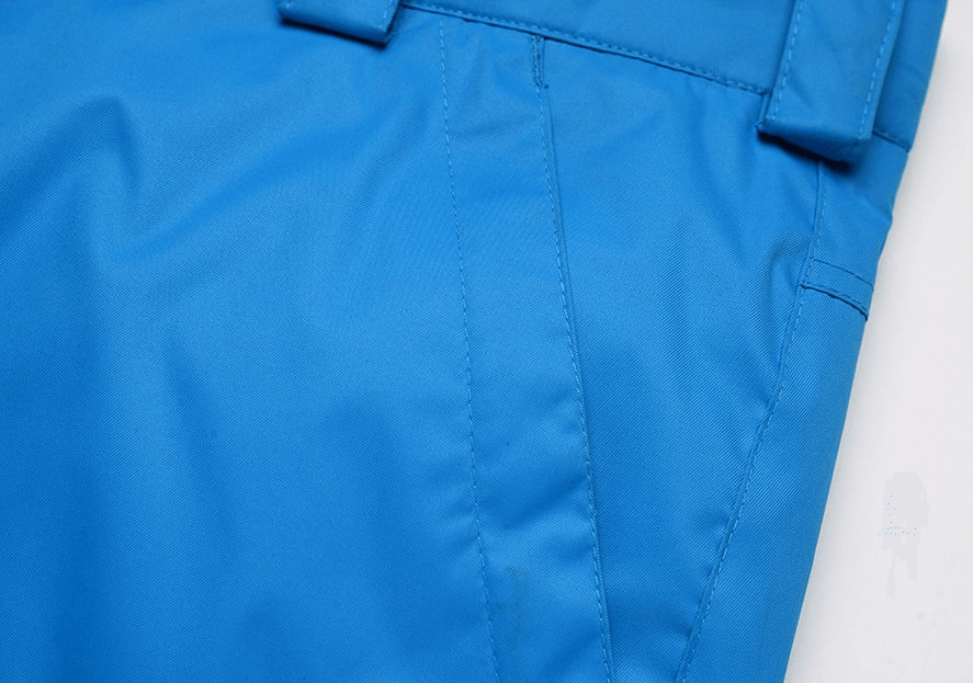 Close-up of blue waterproof windproof insulated men's sports pants with zipper and pocket details, perfect for winter sports.