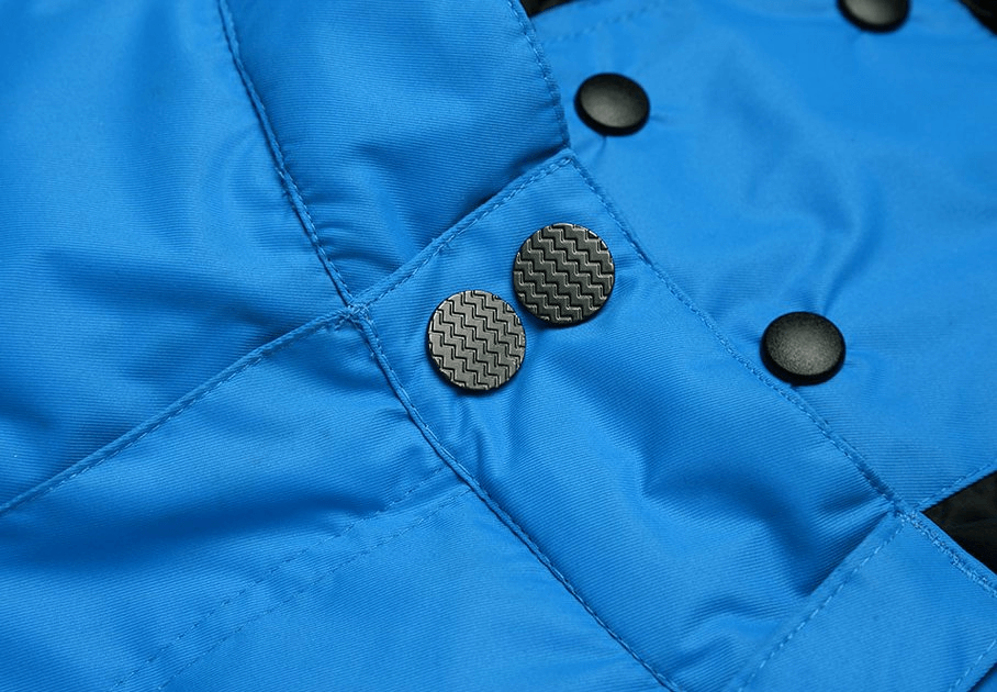 Close-up of blue waterproof windproof insulated men's pants with button details, perfect for winter sports.