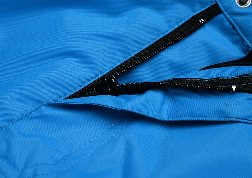 Close-up of waterproof windproof insulated blue sports men's pants with zipper fly closure, ideal for winter sports like snowboarding and skiing.