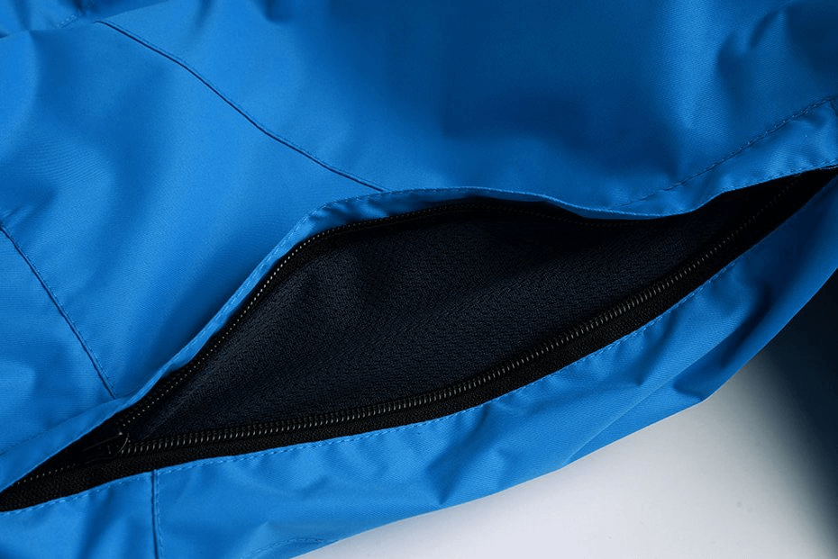Close-up of blue waterproof windproof insulated sports men's pants with zipper detail, perfect for winter sports.