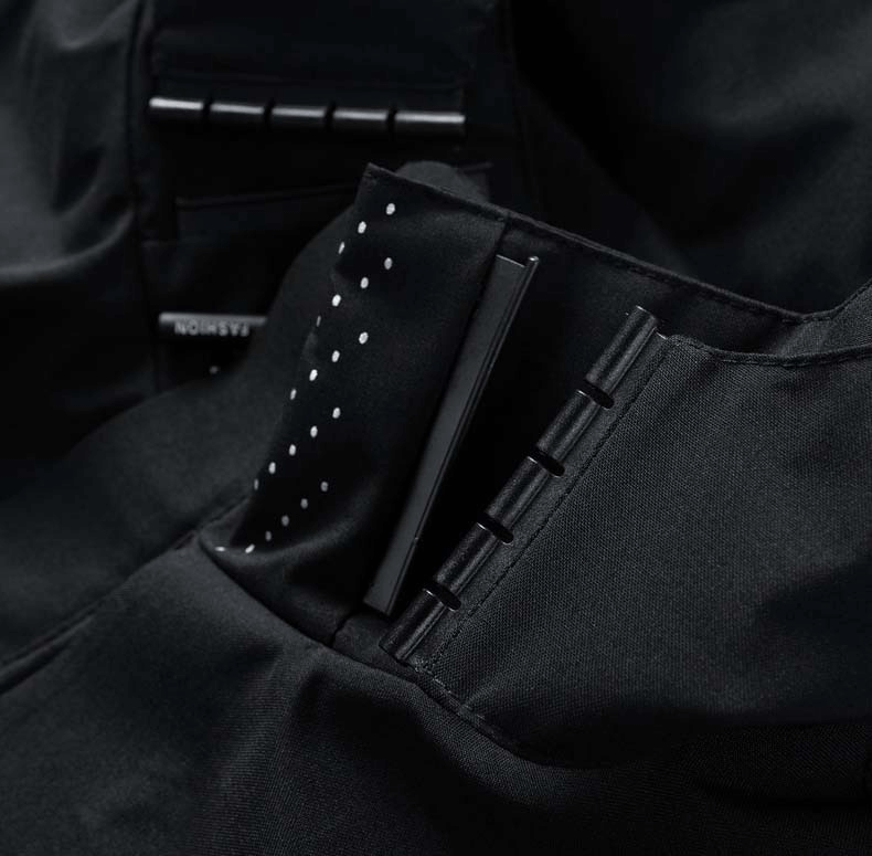 Close-up of black waterproof raincoat with windproof and quick-dry features, highlighting detailed stitching and material texture.