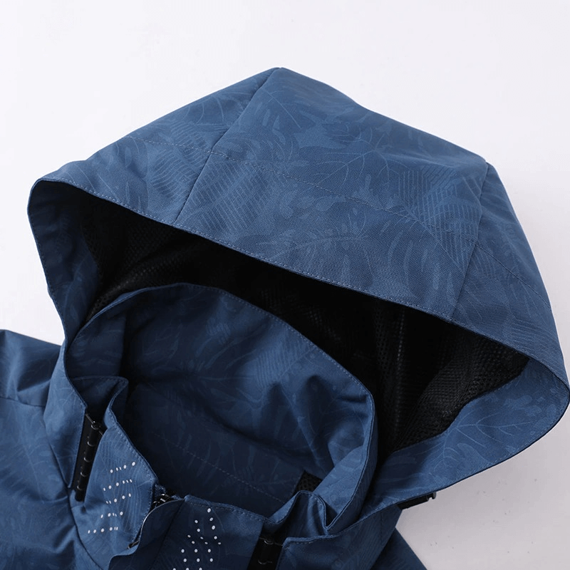 Close-up of a blue waterproof and windproof hooded jacket, perfect for outdoor activities.