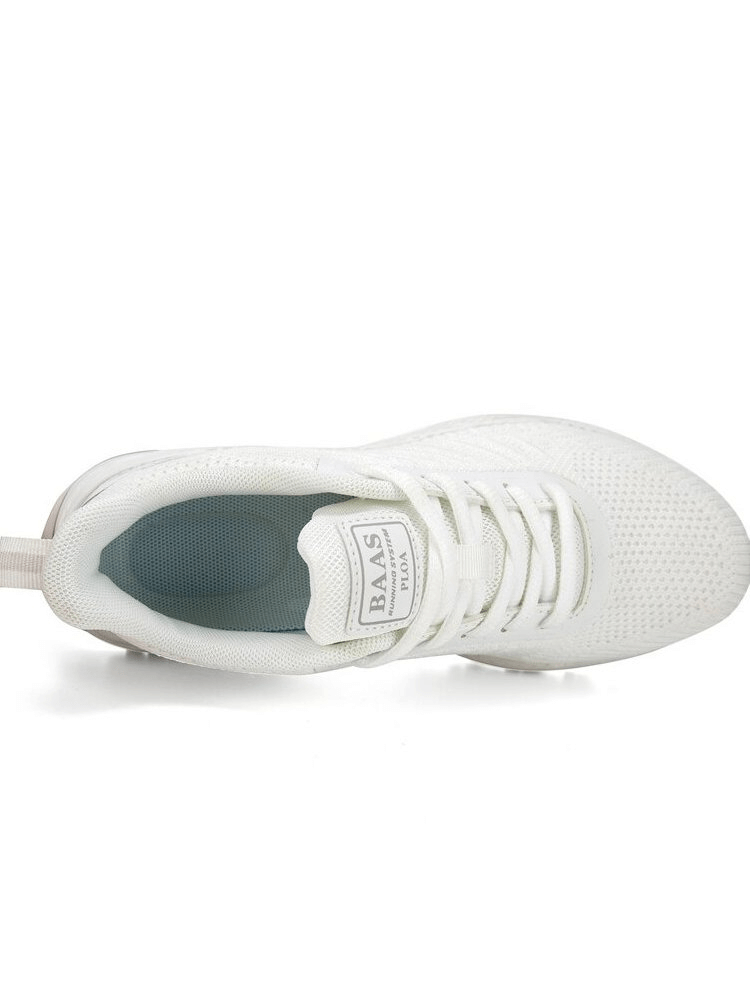 Top view of white wear-resistant non-slip women's sports walking shoe with lace-up closure and breathable mesh design.