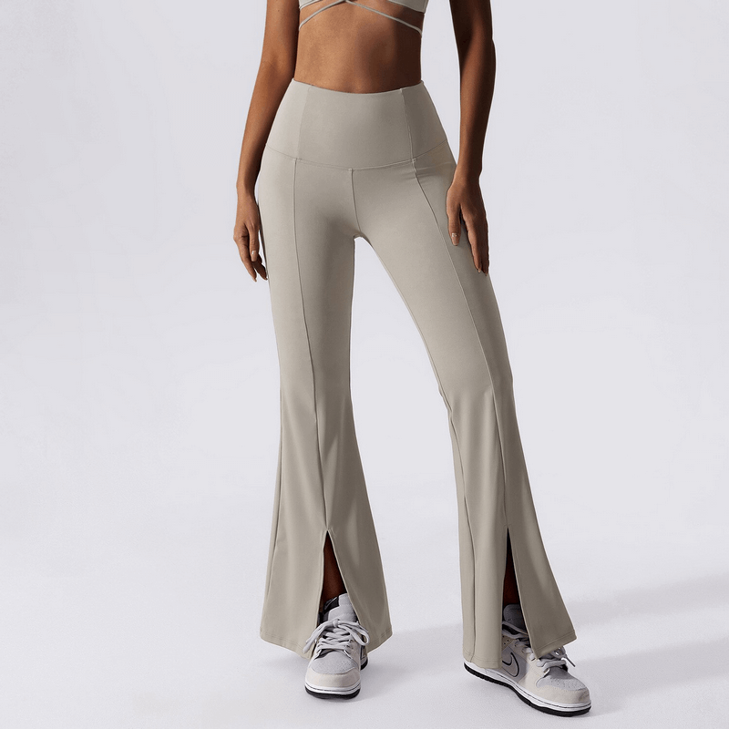 Woman wearing wide leg yoga high waist pants in beige, ideal for fitness and yoga. Stretchy nylon-spandex blend for comfort and flexibility.